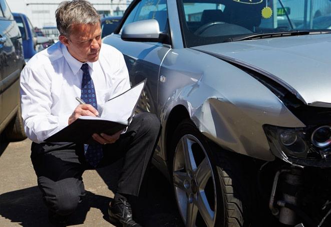 smiling woman holding a car insurance policy